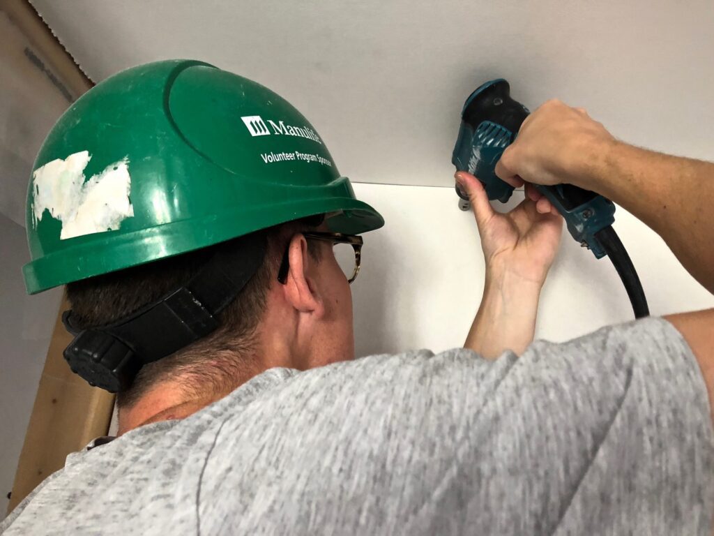 Spencer installing drywall